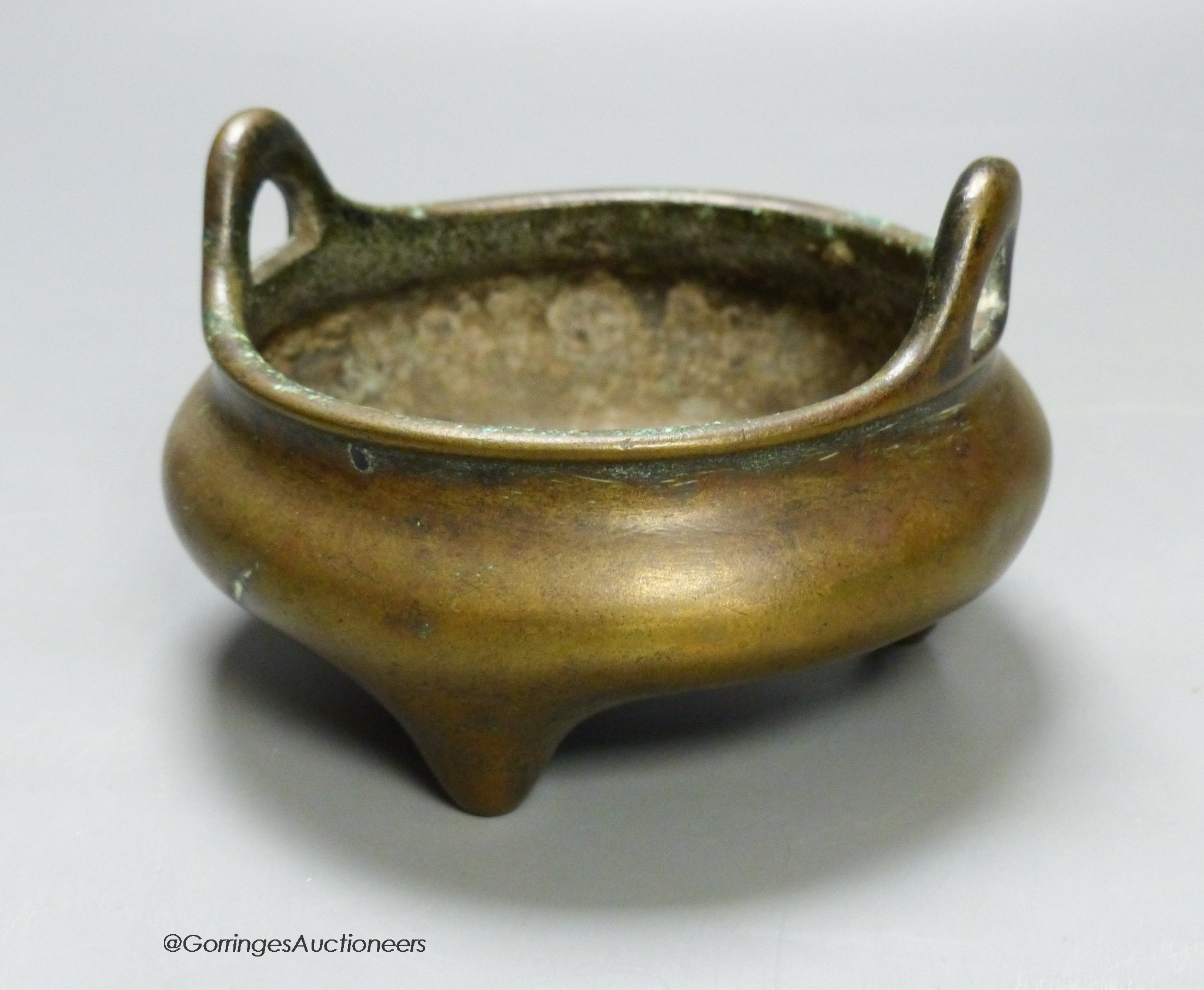 A 19th century Chinese circular bronze tripod censer, diameter 12cm